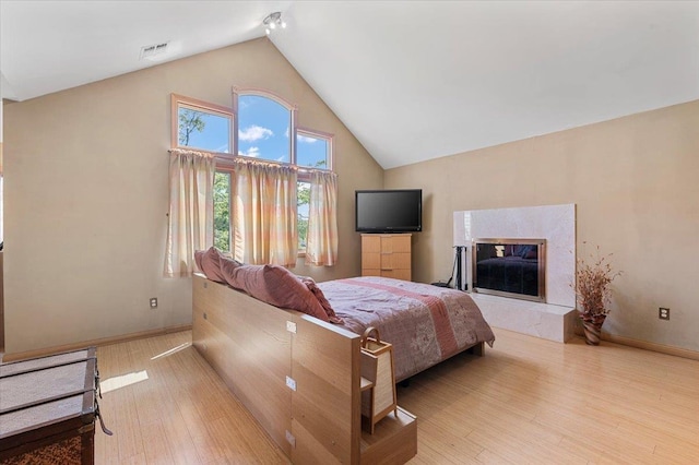 8 Pearl St, Bethpage, NY 11714 - bedroom with wood finished floors, high vaulted ceiling, and a premium fireplace