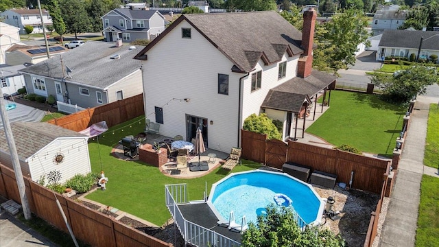 8 Pearl St, Bethpage, NY 11714 - back of house with a fenced backyard, a gate, a residential view, a patio, and an outdoor fire pit