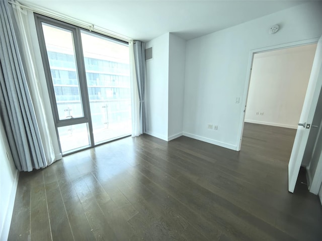 131-05 40th Rd Unit 17L, Flushing, NY 11354 - spare room featuring a smoke detector, dark wood-style floors, and a wall of windows