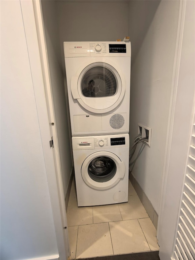 131-05 40th Rd Unit 17L, Flushing, NY 11354 - laundry room featuring stacked washer and clothes dryer and light tile patterned floors