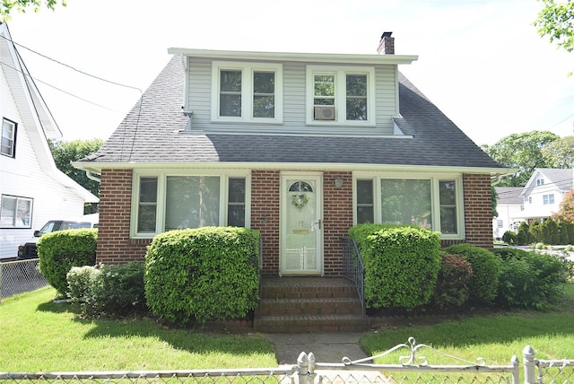 57 Nieman Ave, Lynbrook, NY 11563 - view of front of house featuring brick siding, a chimney, and roof with shingles