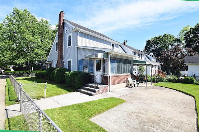 57 Nieman Ave, Lynbrook, NY 11563 - view of front of property with a chimney and brick siding