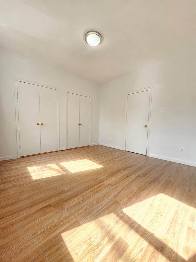 1714 W 12th St, Brooklyn, NY 11223 - unfurnished bedroom with multiple closets and light wood finished floors