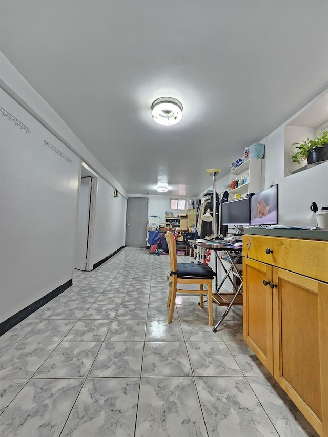 1714 W 12th St, Brooklyn, NY 11223 - kitchen with an office area, brown cabinetry, light marble finish floors, and dark countertops