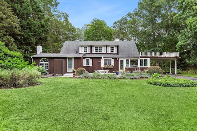 22 Turtle Cove Dr, Southampton, NY 11968 - view of front of house featuring a chimney, a front lawn, a shingled roof, and driveway