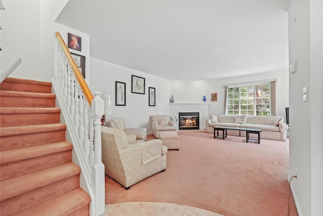 1105 Farmdale Rd, Brewster, NY 10509 - living area with light colored carpet, a glass covered fireplace, and stairway
