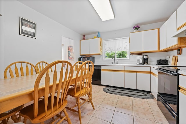 1105 Farmdale Rd, Brewster, NY 10509 - kitchen featuring range, white cabinets, light countertops, light tile patterned floors, and black dishwasher