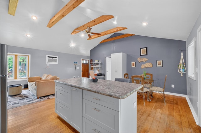 69 Floradan Rd, Putnam Valley, NY 10579 - kitchen with a kitchen island, light wood-style flooring, open floor plan, a wall mounted AC, and recessed lighting