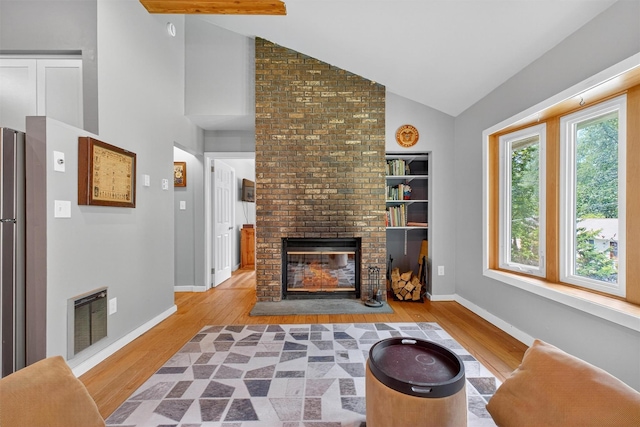 69 Floradan Rd, Putnam Valley, NY 10579 - living area with wood finished floors, a fireplace, and high vaulted ceiling