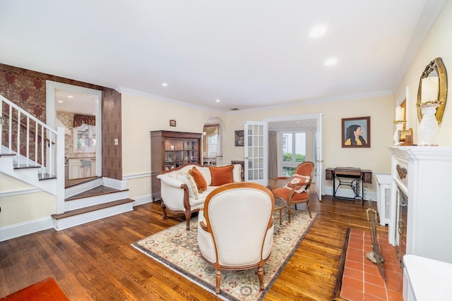 11 Loel Ct, Rockville Centre, NY 11570 - living room featuring arched walkways, stairs, wood finished floors, a fireplace with flush hearth, and crown molding