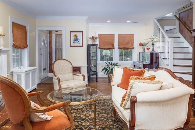 11 Loel Ct, Rockville Centre, NY 11570 - living room featuring stairway, ornamental molding, radiator heating unit, and wood finished floors