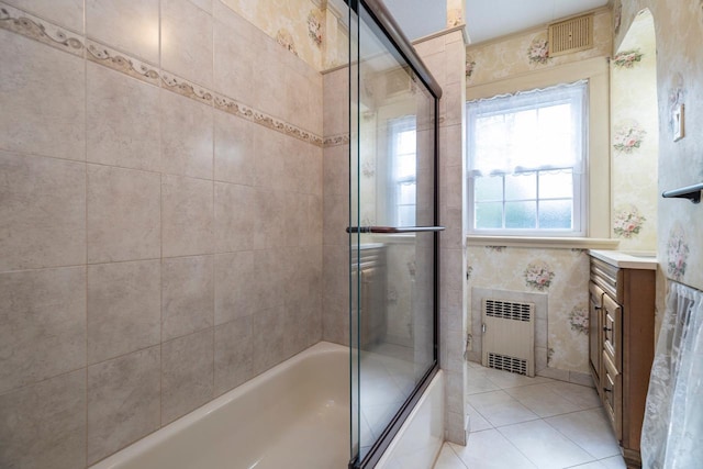 11 Loel Ct, Rockville Centre, NY 11570 - full bath with radiator heating unit, bath / shower combo with glass door, vanity, and tile patterned flooring