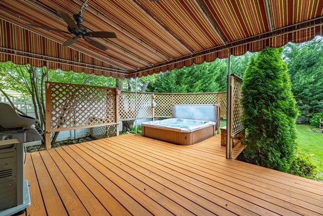 11 Loel Ct, Rockville Centre, NY 11570 - wooden deck with a hot tub, ceiling fan, and grilling area