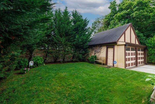 11 Loel Ct, Rockville Centre, NY 11570 - view of grassy yard featuring an outbuilding and a garage