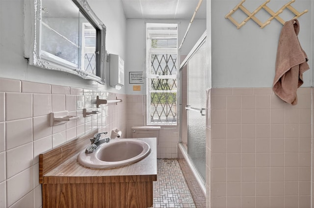 17 Palmetto St, Brooklyn, NY 11221 - bathroom with tile walls, vanity, wainscoting, and shower / bath combination with glass door