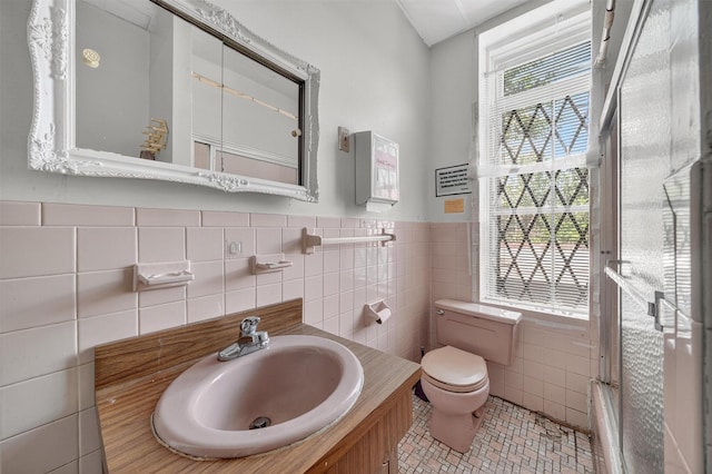 17 Palmetto St, Brooklyn, NY 11221 - bathroom featuring tile walls, vanity, tile patterned floors, wainscoting, and combined bath / shower with glass door