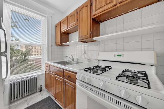 17 Palmetto St, Brooklyn, NY 11221 - kitchen featuring white range with gas stovetop, radiator, light marble finish flooring, light countertops, and healthy amount of natural light