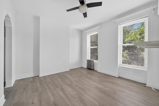 17 Palmetto St, Brooklyn, NY 11221 - unfurnished room with light wood finished floors, radiator heating unit, and a ceiling fan