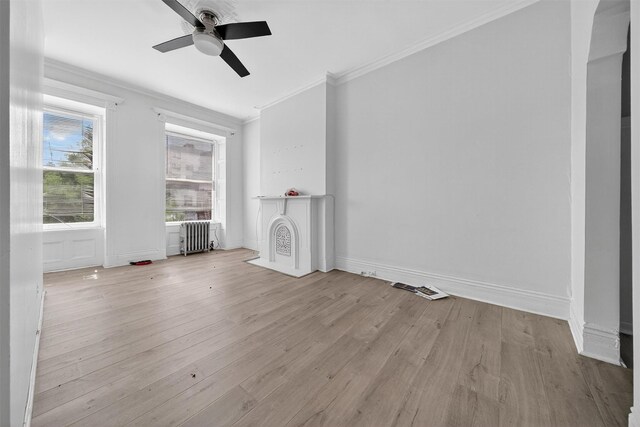 17 Palmetto St, Brooklyn, NY 11221 - unfurnished living room featuring radiator, ornamental molding, wood finished floors, and a ceiling fan