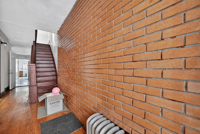 17 Palmetto St, Brooklyn, NY 11221 - staircase with brick wall and wood finished floors