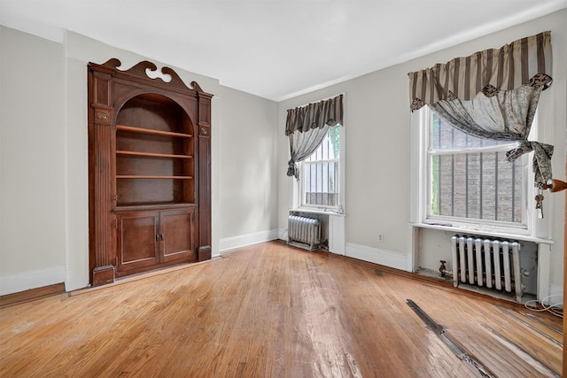 17 Palmetto St, Brooklyn, NY 11221 - unfurnished living room with radiator heating unit and light wood-type flooring