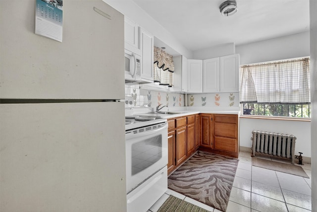 17 Palmetto St, Brooklyn, NY 11221 - kitchen featuring white appliances, radiator, light countertops, white cabinetry, and light tile patterned flooring
