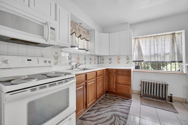 17 Palmetto St, Brooklyn, NY 11221 - kitchen with white appliances, radiator heating unit, light countertops, brown cabinets, and decorative backsplash