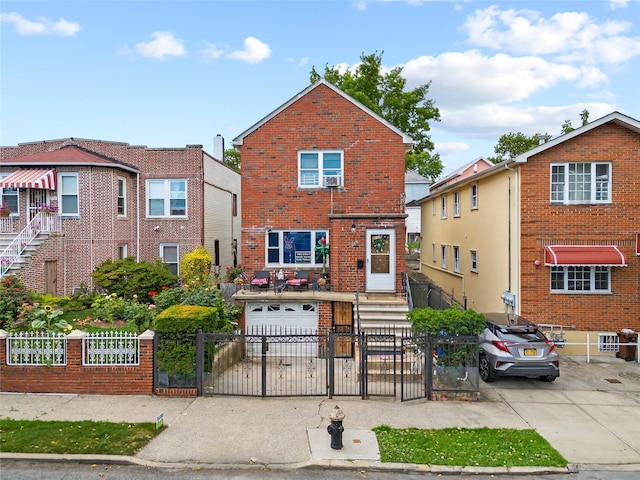 2719 Hering Ave, Bronx, NY 10469 - traditional home featuring brick siding, driveway, an attached garage, and a gate