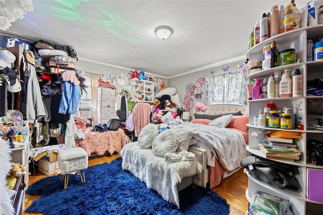 2719 Hering Ave, Bronx, NY 10469 - bedroom with wood finished floors, crown molding, and cooling unit