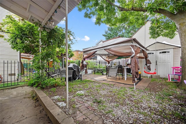 2719 Hering Ave, Bronx, NY 10469 - fenced backyard featuring a storage shed, a patio area, and outdoor dining space