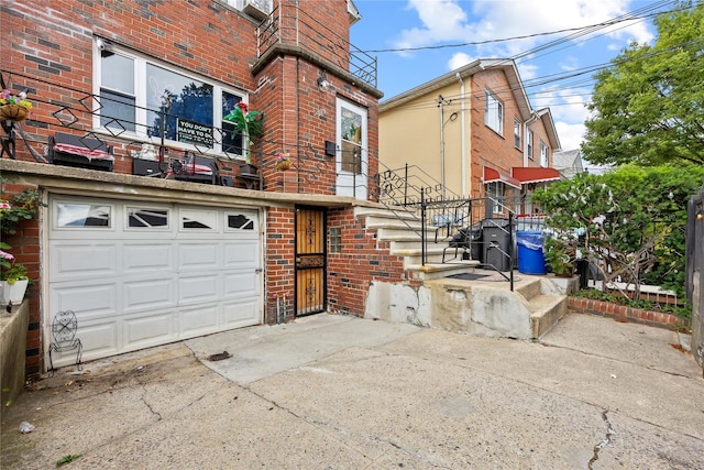 2719 Hering Ave, Bronx, NY 10469 - view of front of home featuring brick siding, concrete driveway, and an attached garage