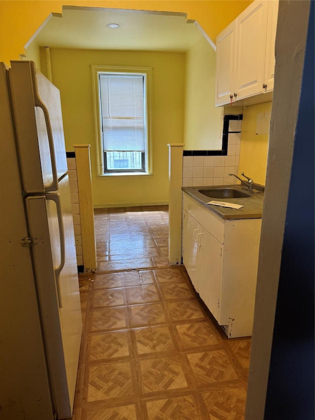 2922 Barnes Ave Unit 3A, Bronx, NY 10467 - kitchen featuring freestanding refrigerator, white cabinets, tasteful backsplash, and dark countertops