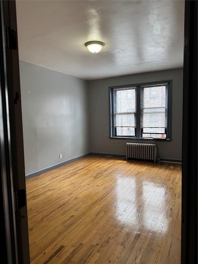 2922 Barnes Ave Unit 3A, Bronx, NY 10467 - unfurnished room featuring radiator and hardwood / wood-style flooring