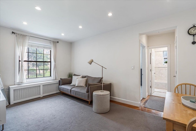 30-69 Hobart St Unit 2P, Woodside, NY 11377 - living area with radiator heating unit, recessed lighting, and wood finished floors