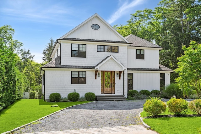 5 Kings Ln, Southampton, NY 11968 - view of front of house with a front yard, roof with shingles, gravel driveway, and board and batten siding