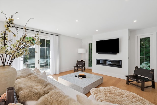 5 Kings Ln, Southampton, NY 11968 - living room featuring light wood finished floors, a glass covered fireplace, and recessed lighting