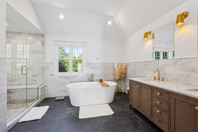 5 Kings Ln, Southampton, NY 11968 - full bath featuring lofted ceiling, tile walls, a stall shower, a freestanding bath, and double vanity