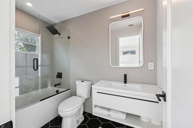 5 Kings Ln, Southampton, NY 11968 - bathroom with tile walls, combined bath / shower with glass door, vanity, and tile patterned floors