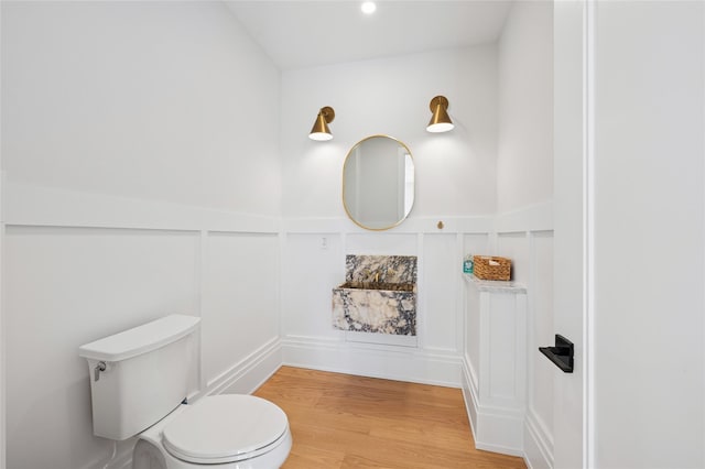 5 Kings Ln, Southampton, NY 11968 - bathroom featuring a decorative wall, wood finished floors, and a wainscoted wall