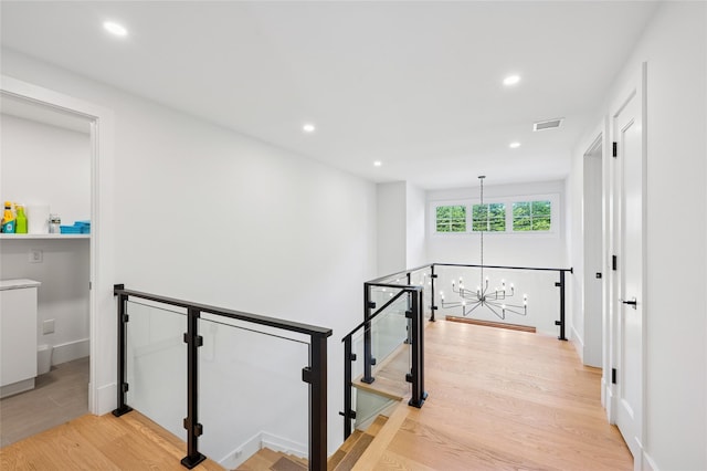 5 Kings Ln, Southampton, NY 11968 - hall featuring an upstairs landing, a chandelier, light wood-style floors, and recessed lighting