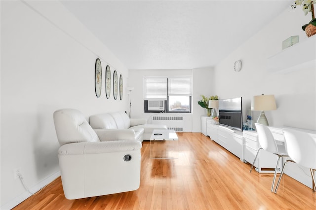 139-09 28th Rd Unit 6F, Flushing, NY 11354 - living room with radiator heating unit, light wood finished floors, and cooling unit