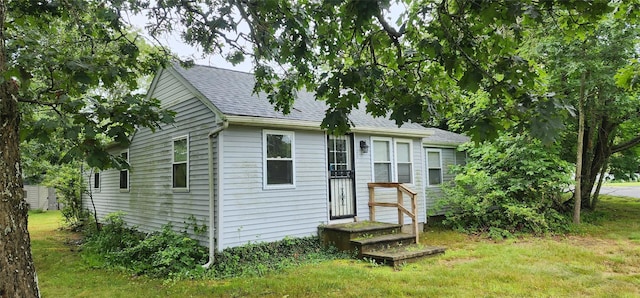 344 Elm Rd W, Mastic Beach, NY 11951 - view of front of house featuring a shingled roof and a front lawn