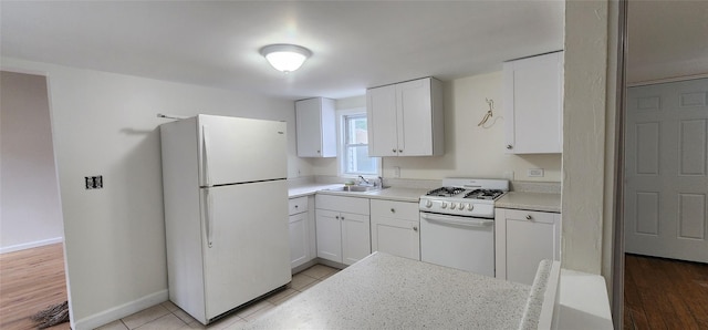 344 Elm Rd W, Mastic Beach, NY 11951 - kitchen featuring white appliances, white cabinets, and light countertops