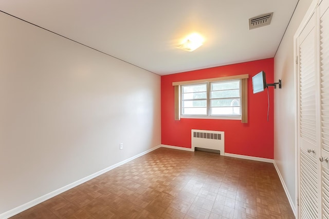61 Ulster Ave, West Babylon, NY 11704 - unfurnished bedroom with radiator and baseboards