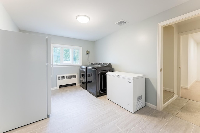 61 Ulster Ave, West Babylon, NY 11704 - laundry room with radiator heating unit and independent washer and dryer