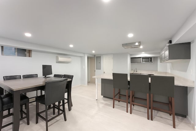 61 Ulster Ave, West Babylon, NY 11704 - dining space with a wall unit AC, electric panel, bar with sink, and recessed lighting