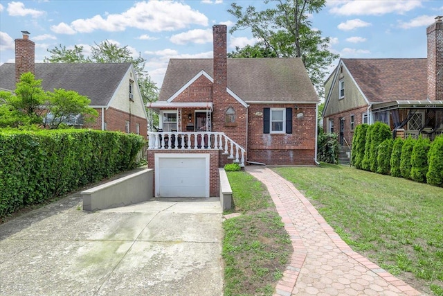 22324 Murdock Ave, Queens Village, NY 11429 - tudor-style house featuring brick siding, concrete driveway, a front yard, an attached garage, and a chimney