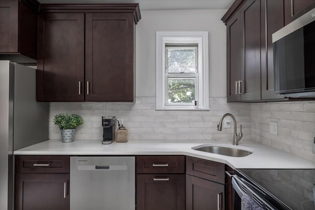 22324 Murdock Ave, Queens Village, NY 11429 - kitchen with appliances with stainless steel finishes, backsplash, dark brown cabinets, and light countertops