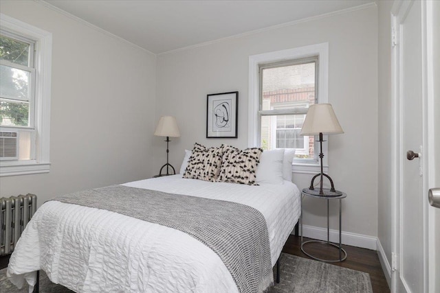 22324 Murdock Ave, Queens Village, NY 11429 - bedroom featuring radiator heating unit, wood finished floors, multiple windows, and crown molding