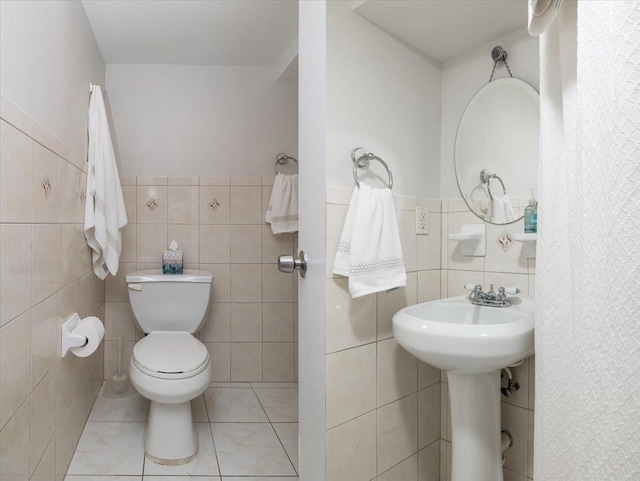 22324 Murdock Ave, Queens Village, NY 11429 - bathroom featuring tile walls, tile patterned floors, and wainscoting